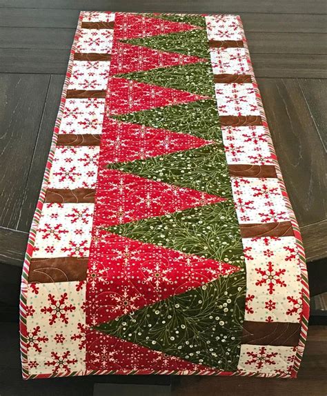 A Table Runner With Red And Green Christmas Decorations