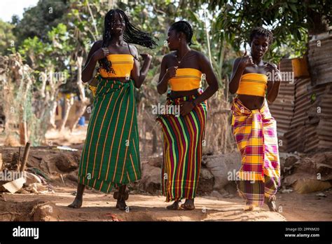 Full Body Of Positive African Girls In Traditional Clothes Dancing On