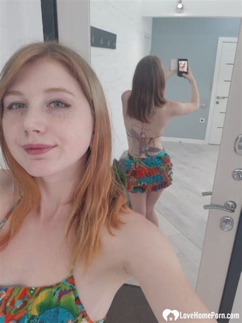 Hot Redheaded Girl Doffs Her Colorful Dress And Poses Naked In The