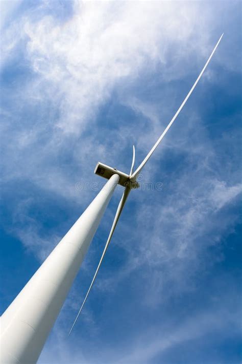 Low Angle View Of A Wind Turbine Against Blue Sky Stock Image Image