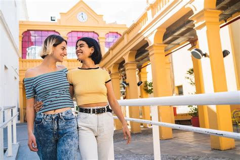 Premium Photo Smiling Lesbian Couple Standing Against Building Outdoors