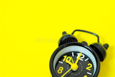 Vintage Black Alarm Clock Isolated On Yellow Background With Space For