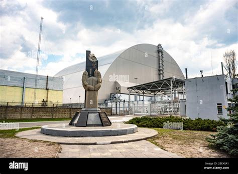 Chernobyl Nuclear Power Plant With Shelter And Monument In Memory Of