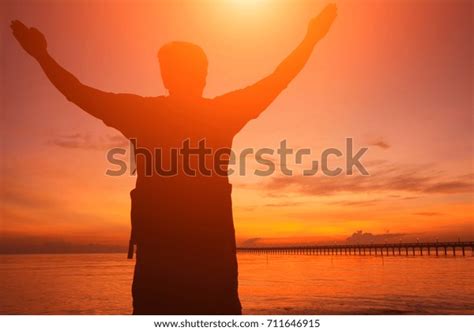 Silhouette Man Hands Raised Beautiful Sunrise Stock Photo