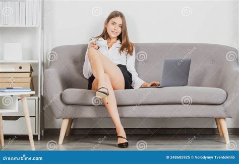 Beautiful Secretary With Legs Sit On Sofa In Office Business Woman With Laptop On Sofa Stock