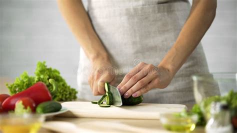 Woman Preparing Salad At The Kitchen Female Hands Cutting Cucumber