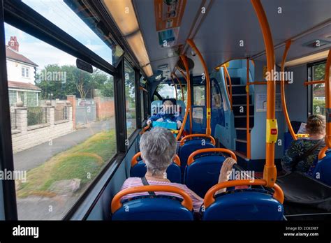 People Wearing Face Masks Sitting On A Bus Journey Sit Apart During Social Distance Rules Stock