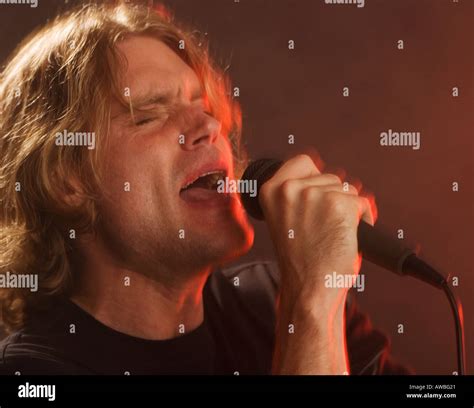 Man Singing Into Microphone Stock Photo Alamy