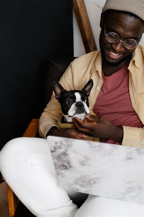 Black man with dog and laptop · Free Stock Photo