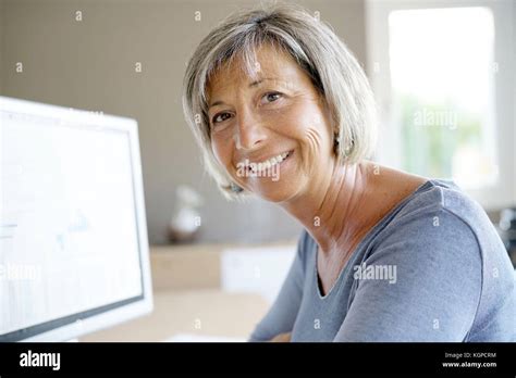 Portrait Of Mature Businesswoman Working On Desktop Stock Photo Alamy