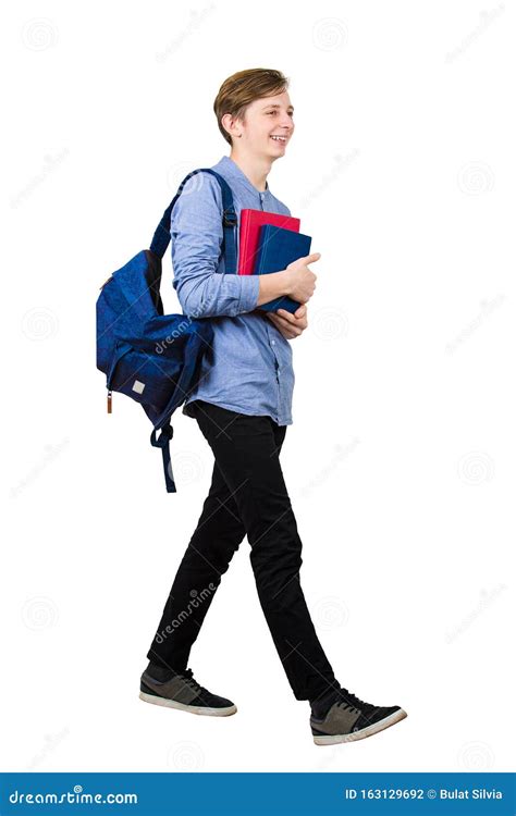 Full Length Portrait Of Confident Student Boy Going To School Holding