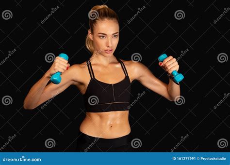 Determined Woman Exercising With Dumbbells Studio Shot Stock Image