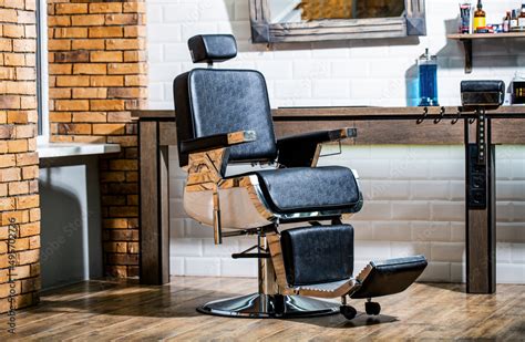 Professional hairstylist in barbershop interior. Barber shop chair ...