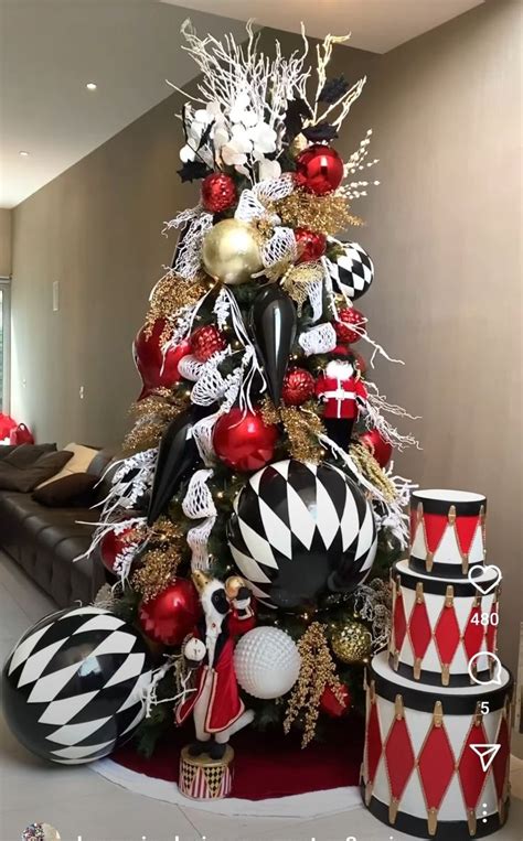 A Christmas Tree Decorated With Black White And Red Ornaments