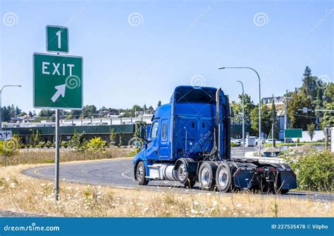 Big Rig Blue Bonnet Semi Truck Tractor Turning On The Highway Exit