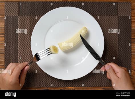 Top View Man Eating A Fresh Banana With Fork And Knife Stock Photo Alamy