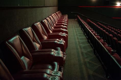 Premium Photo | A row of red leather chairs in a movie theater