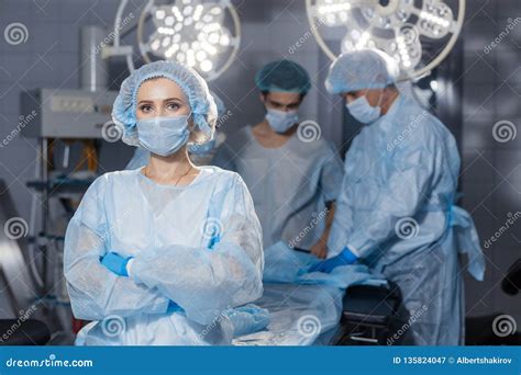 Serious Concentrated Female Surgeon In Surgical Uniform At Operating