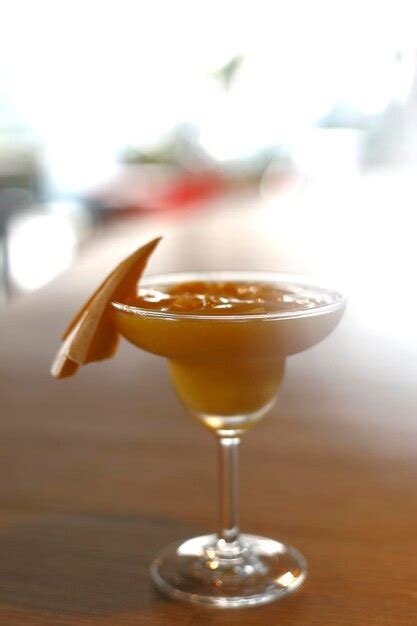 Premium Photo Close Up Shoot Of Fresh Mango Smoothie On Martini Glass Served On The Table