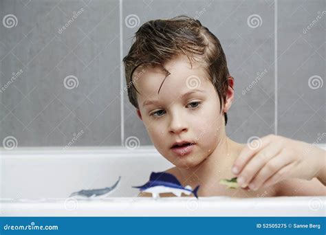 Boy with toys in bath stock image. Image of shot, indoors - 52505275