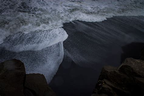 Time Lapse Photography Of Body Of Water On Seashore Near Rock Mountain