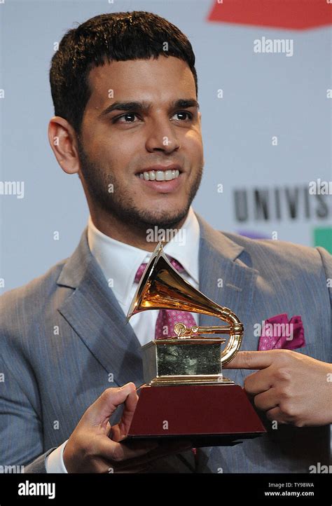 Contemporary Tropical Album Winner Tito El Bambino Holds Trophy For