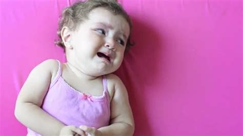 Little Latina baby lying on the pink bed... | Stock Video | Pond5