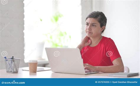 Indian Woman Having Neck Pain While Using Laptop In Office Stock Image