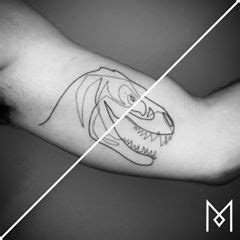 An Arm With A Drawing Of A Dinosaur On It And The Words Mean Written In