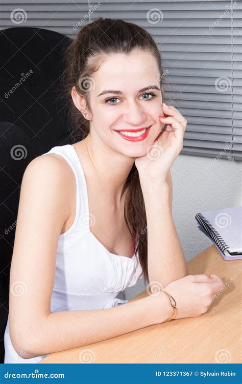 Young Businesswoman Sit In Office Desk Hand Under Chin Stock Image