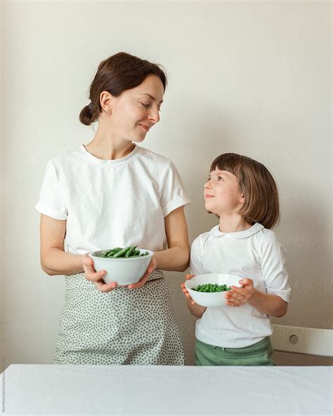 Mother And Daughter With Peas By Stocksy Contributor Duet