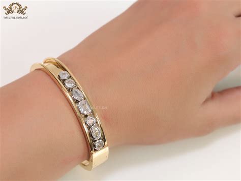 Openable Broad Gold Plated Bracelet With Dancing Fancy Cut Diamonds