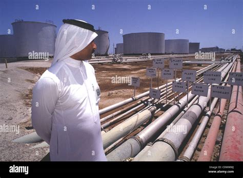 ras tanura, saudi arabia -- a saudi official looks over oil pipelines ...