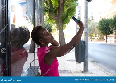 Young And Beautiful Afro American Woman Sitting At The Bus Stop