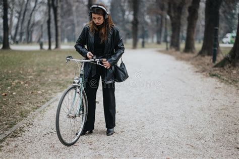 Elegant Businesswoman With Bicycle In Park Portraying Confidence And