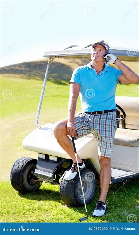 Making Calls From His Mobile Office A Mature Golfer Standing Next To