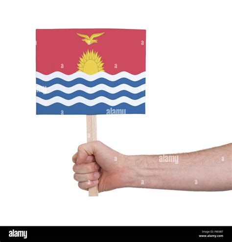 Hand Holding Small Card Isolated On White Flag Of Kiribati Stock