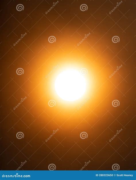 A Hazy Orange Sun Due To Wildfire Smoke In The Atmosphere Stock Photo