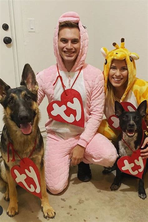 Three People In Costumes Posing With Two Dogs