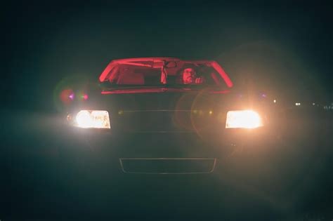 Premium Photo Cinematic Scene Of A Man Driving A Car With Red Lights