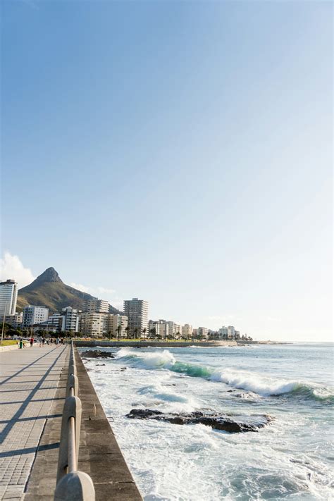Body of water near city buildings during daytime photo – Free Beach