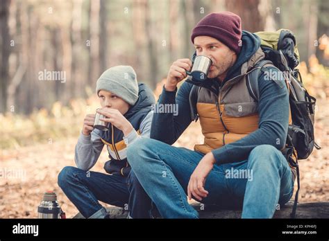 Father And Son Drinking Tea In Forest Stock Photo Alamy