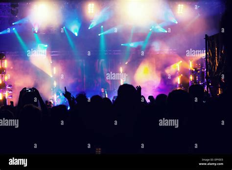 Cheering Crowd In Front Of Bright Colorful Stage Lights Retro Styled