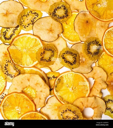 The Dry Pieces Of Different Fruits In A Row To Fresh Fruits Stock Photo