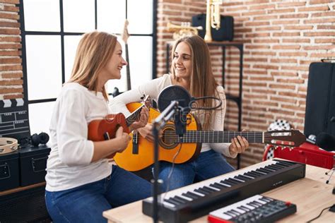 Two Women Musicians Singing Song Playing Classical Guitar And Ukulele