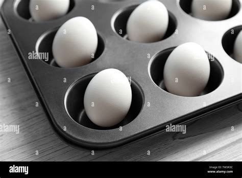 Hard boiled eggs in muffin tin on table Stock Photo - Alamy