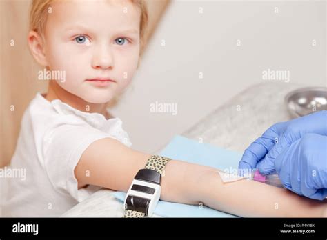 Doctor Or Nurse Ready To Take A Blood Sample From Little Girls Arm