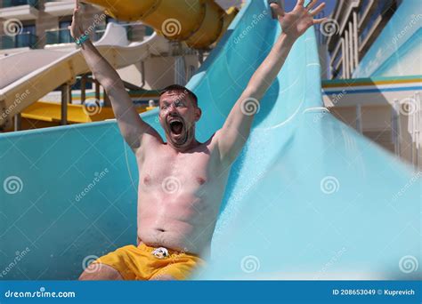 Joyful Man Slides Down Slide In Water Park Stock Image Image Of