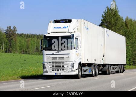 White Volvo Fh Truck Pulls Semi Trailer On Highway E On A Beautiful