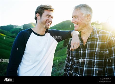 Caucasian Father And Son Smiling On Rural Hilltop Stock Photo Alamy